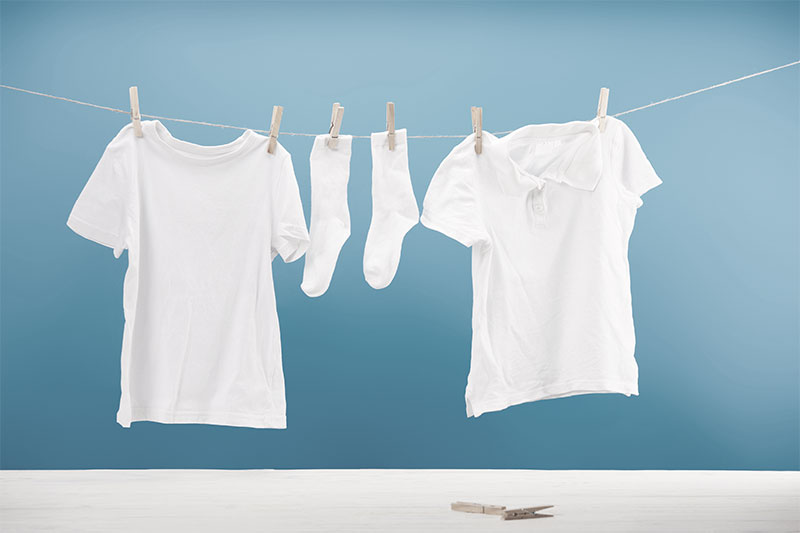 Dried Clothes By Using A Clothesline