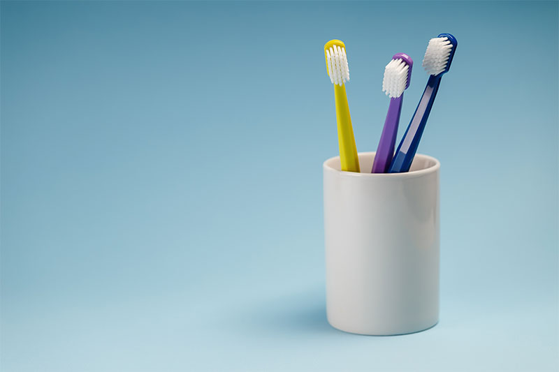 Toothbrushes and toothbrush holders