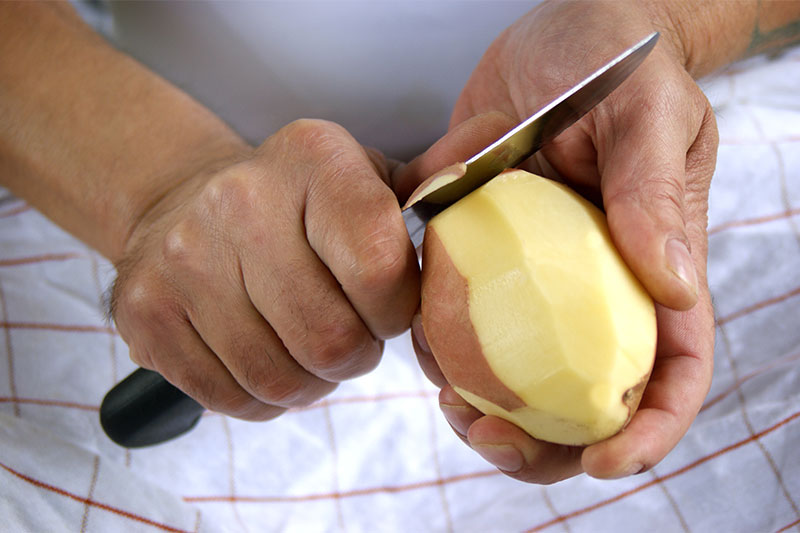 Removing the peels potatoes